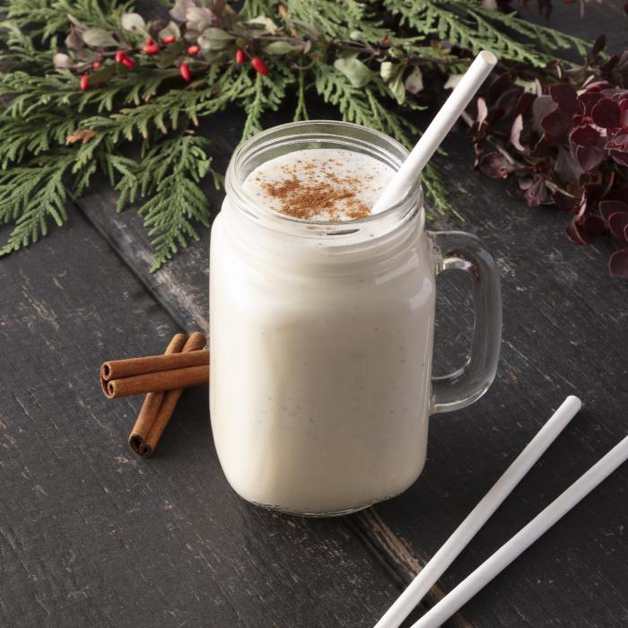 Glass jar filled with eggnog and topped with a Hefty ECOSAVE straw