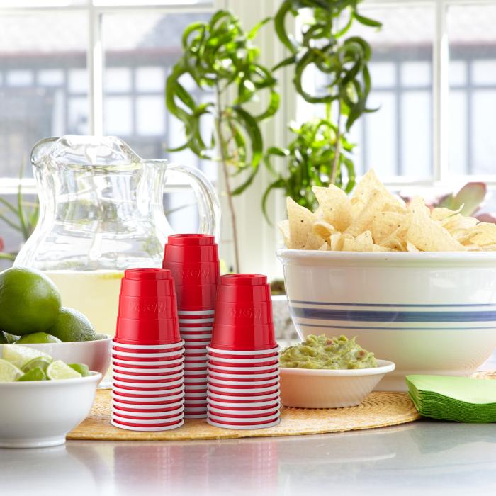 Hefty 2 oz Party cup on table with snacks