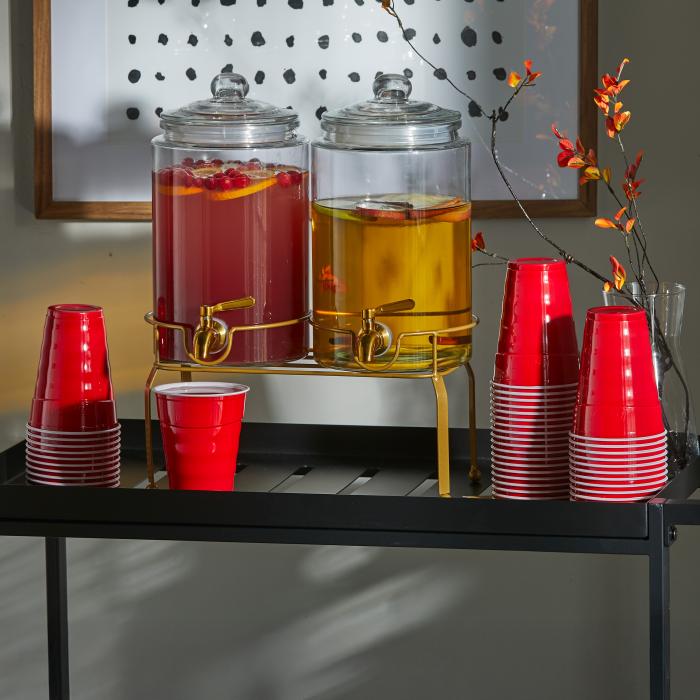 Hefty 18oz red party cups sitting on a beverage cart with a drink dispenser