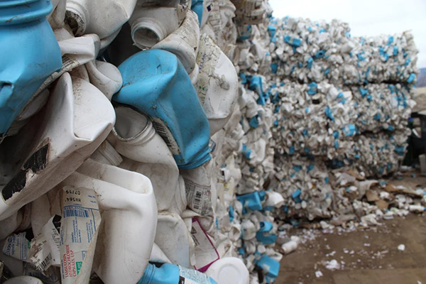 mounds of plastic containers at garbage dump