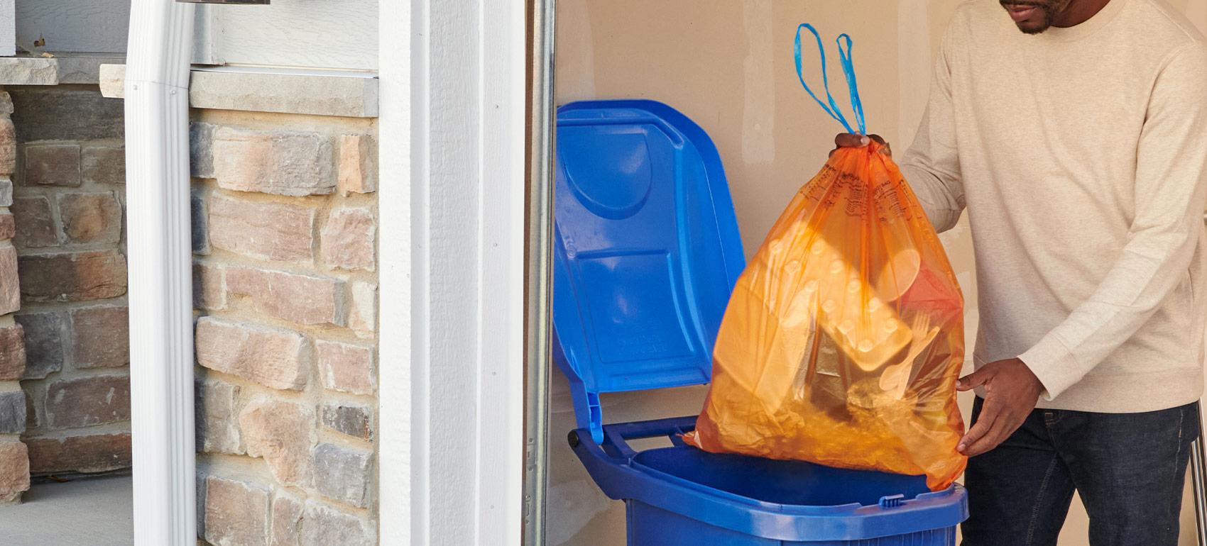 main putting Hefty ReNew bag in bin