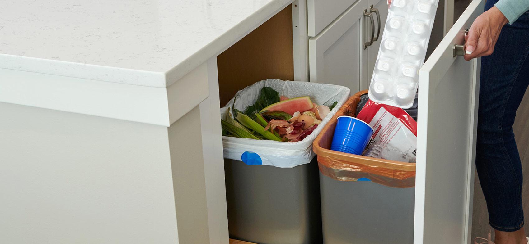 Person in kitchen adding recycled items to ReNew bag